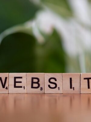 Scrabble tiles on a wooden surface forming the word 'Website', symbolizing digital communication.